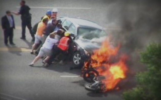 Image Credit: http://www2.counton2.com/news/2011/sep/13/caught-tape-bystanders-lift-car-pull-biker-burning-ar-2402025/