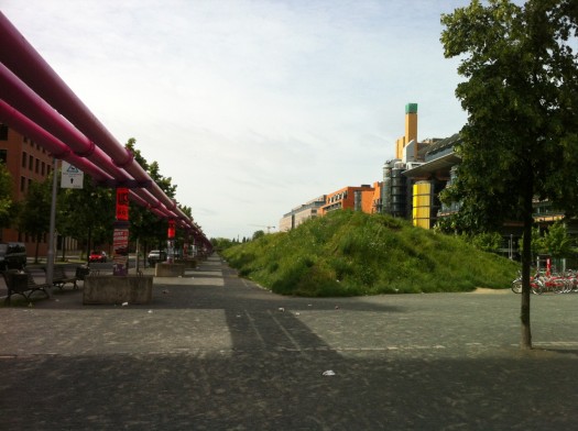 The large pink pipes are temporary for construction only, to service the high water table. Although why they weren’t placed a block over instead of through the heart of the principal square is questionable.