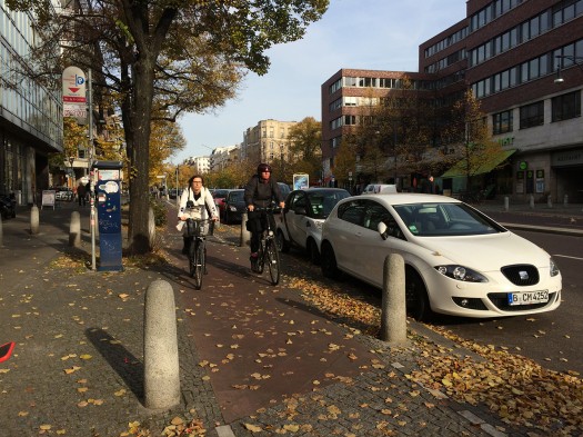 On busier streets, the separated cycling lane mounts the curb, and is separated from the pedestrian sidewalk by punitively bumpy pavers.