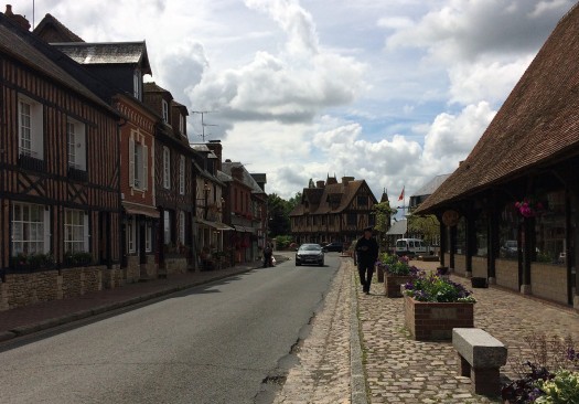 Skinny street has buildings with zero setbacks from the sidewalk, forming a street wall and sense of enclosure.